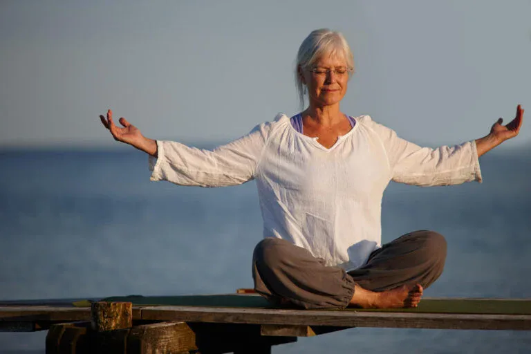 become calm like ocean full length shot attractive mature woman doing yoga pier out ocean