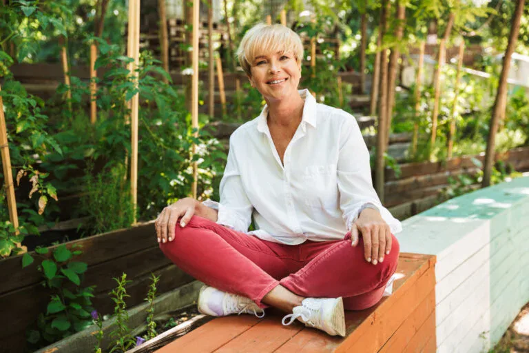smiling mature woman sitting with legs crossed