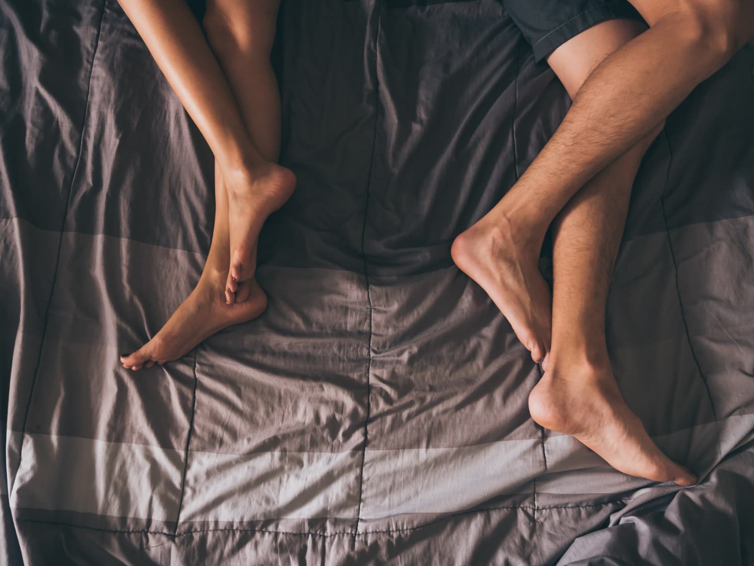 close up legs couple bed
