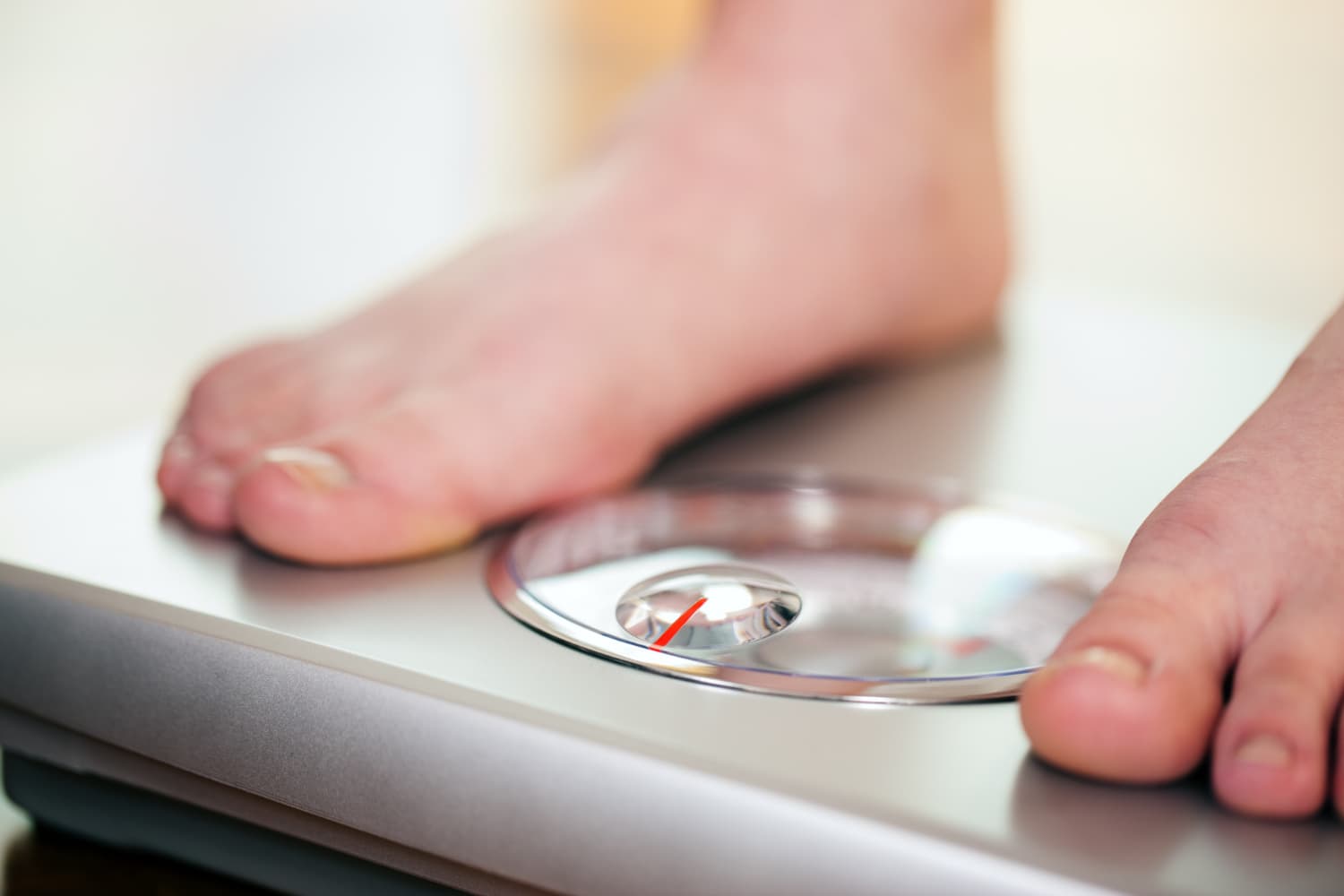 woman standing bathroom scale