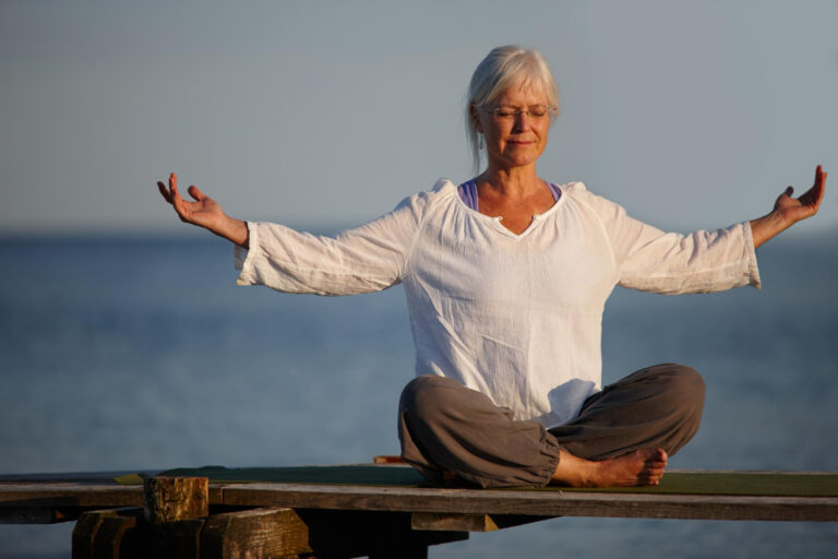 become calm like ocean full length shot attractive mature woman doing yoga pier out ocean